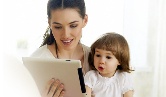 woman and child looking at tablet