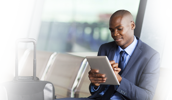 man in airport on tablet