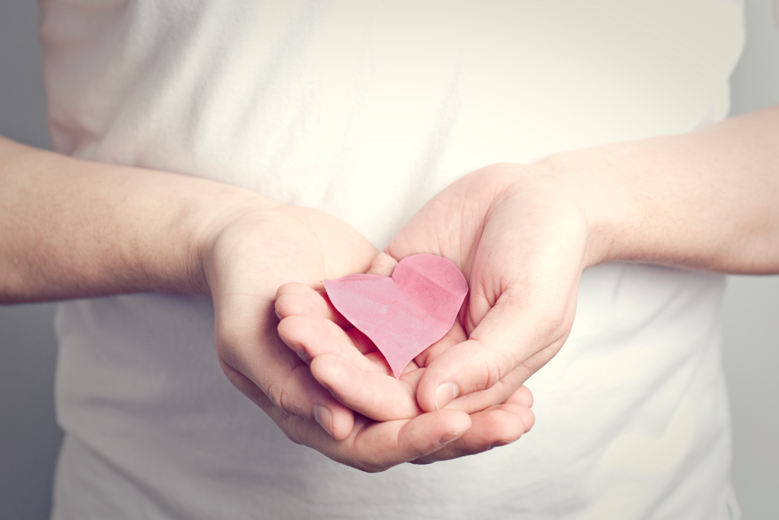 hands holding paper heart