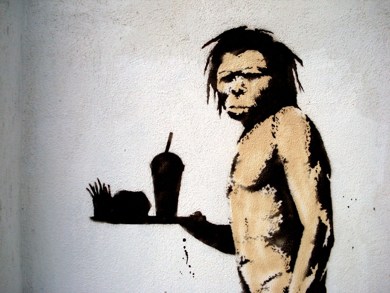 caveman holding fast food silhouette banksy street art 