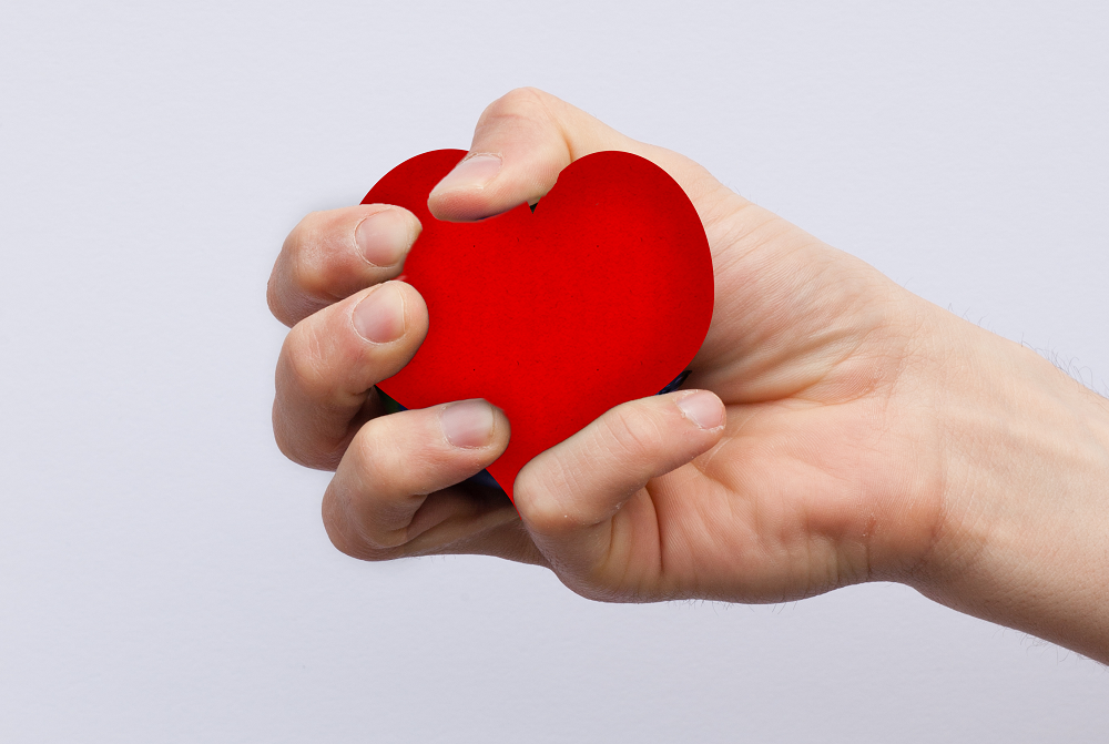 squeezing a heart shaped stress ball